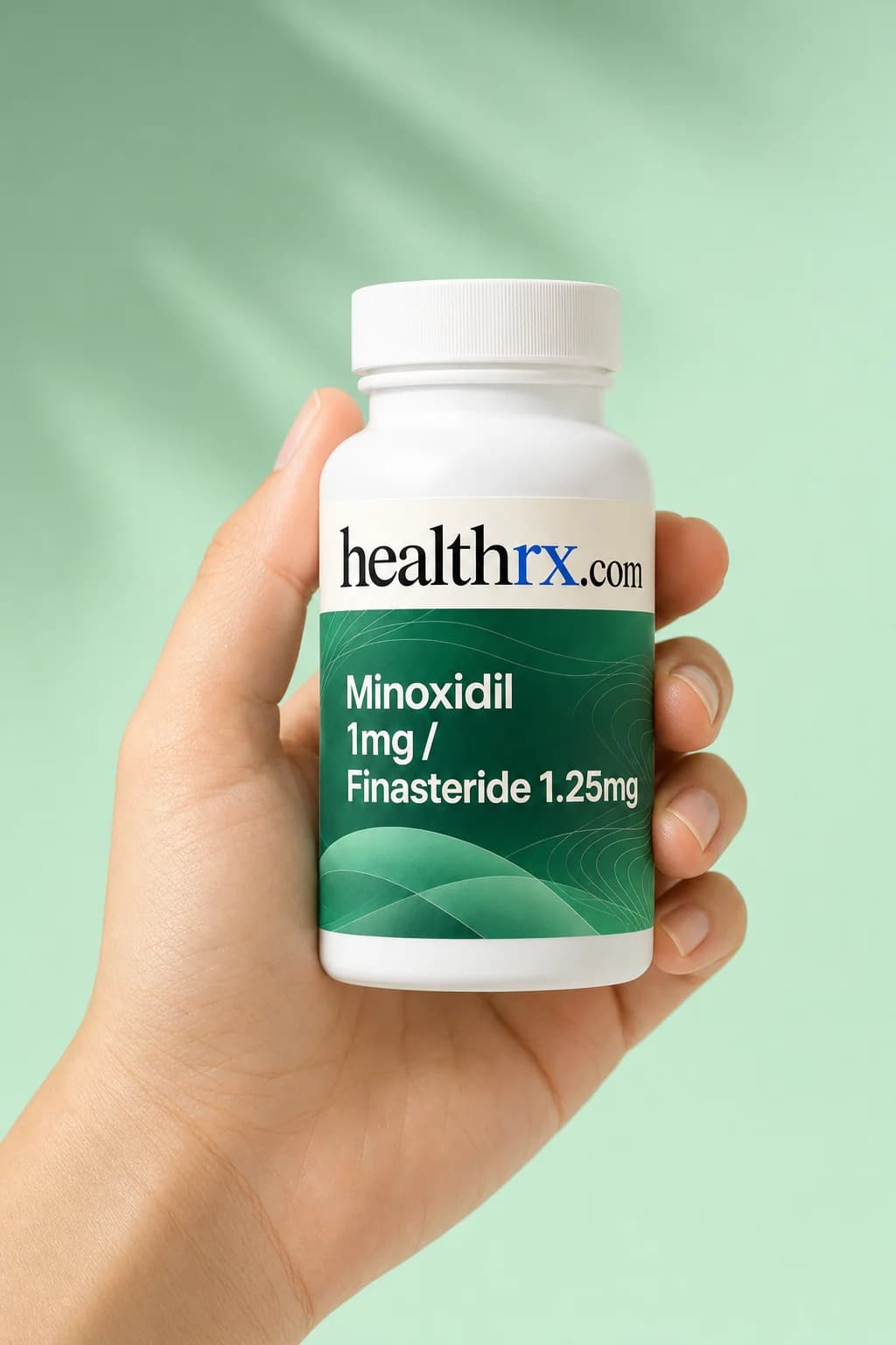 Minoxidil 1mg / Finasteride 1.25mg held in one hand, showing its size