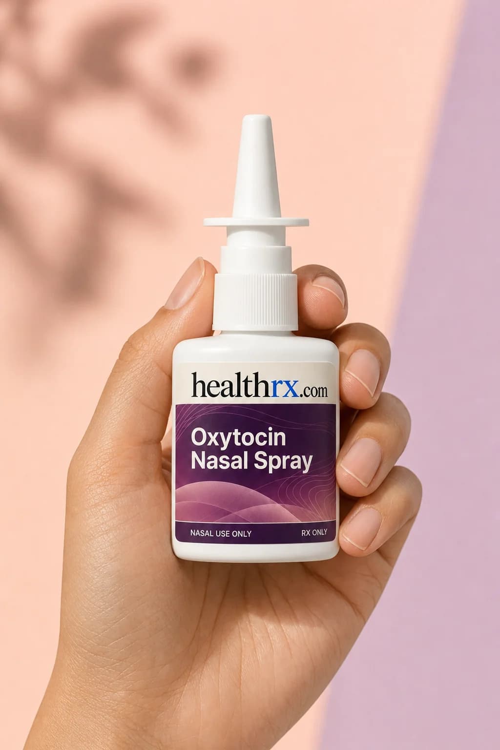 Oxytocin Nasal Spray held in one hand, showing its size