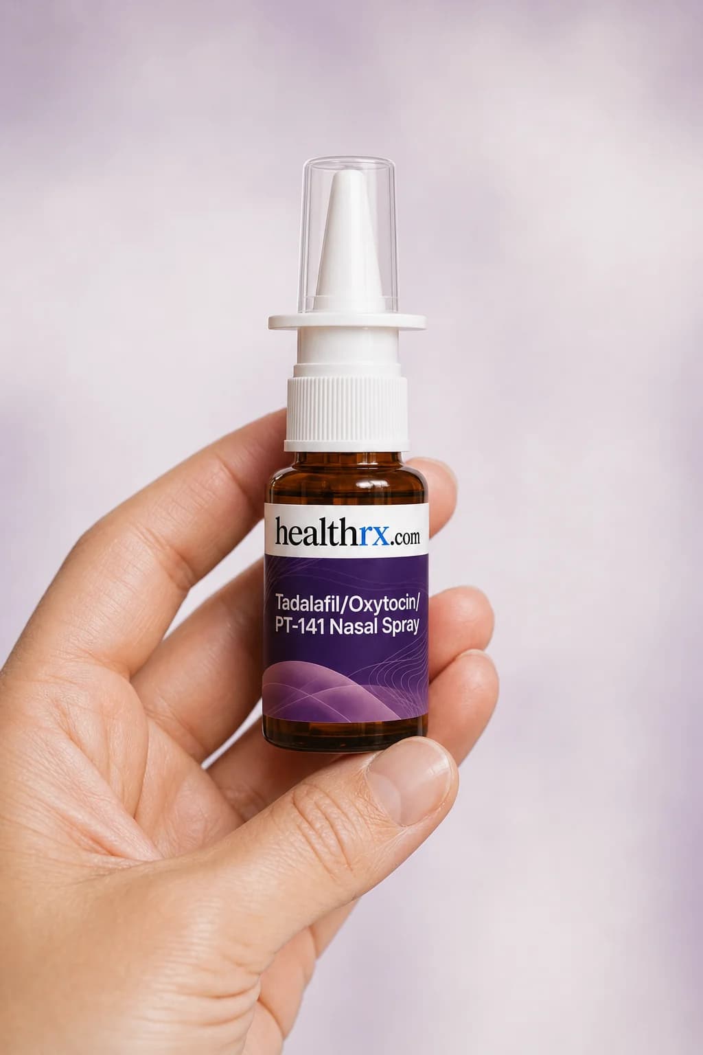 Tadalafil / Oxytocin / PT-141 Nasal Spray held in one hand, showing its size