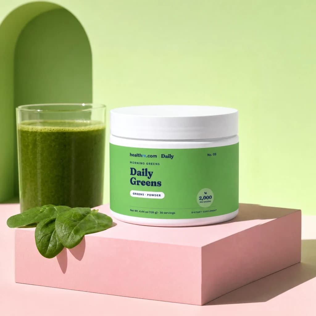 Daily Greens by HealthRX.com in its powder packaging, on a colored pedestal