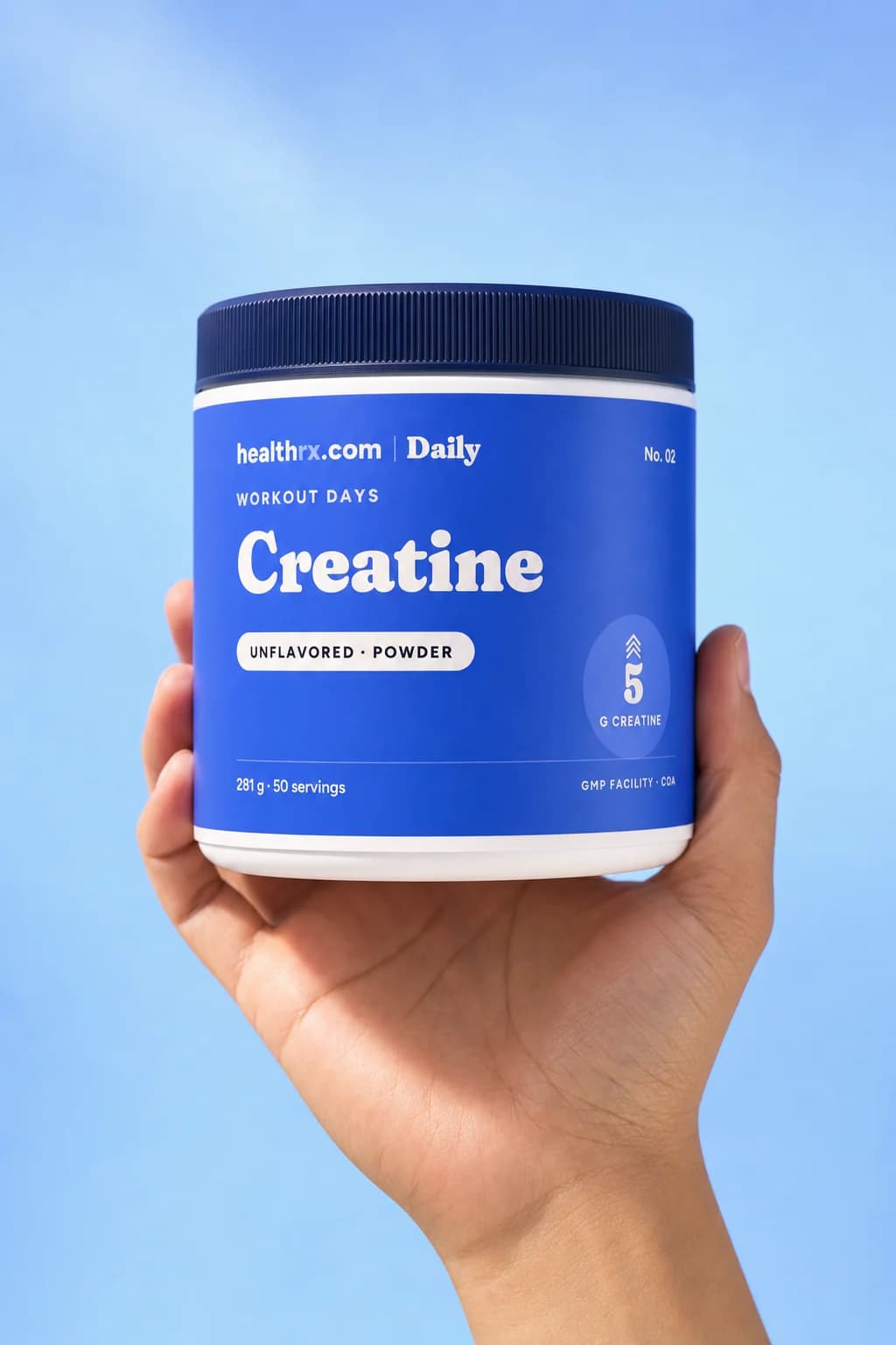 Daily Creatine in a hand, showing its size