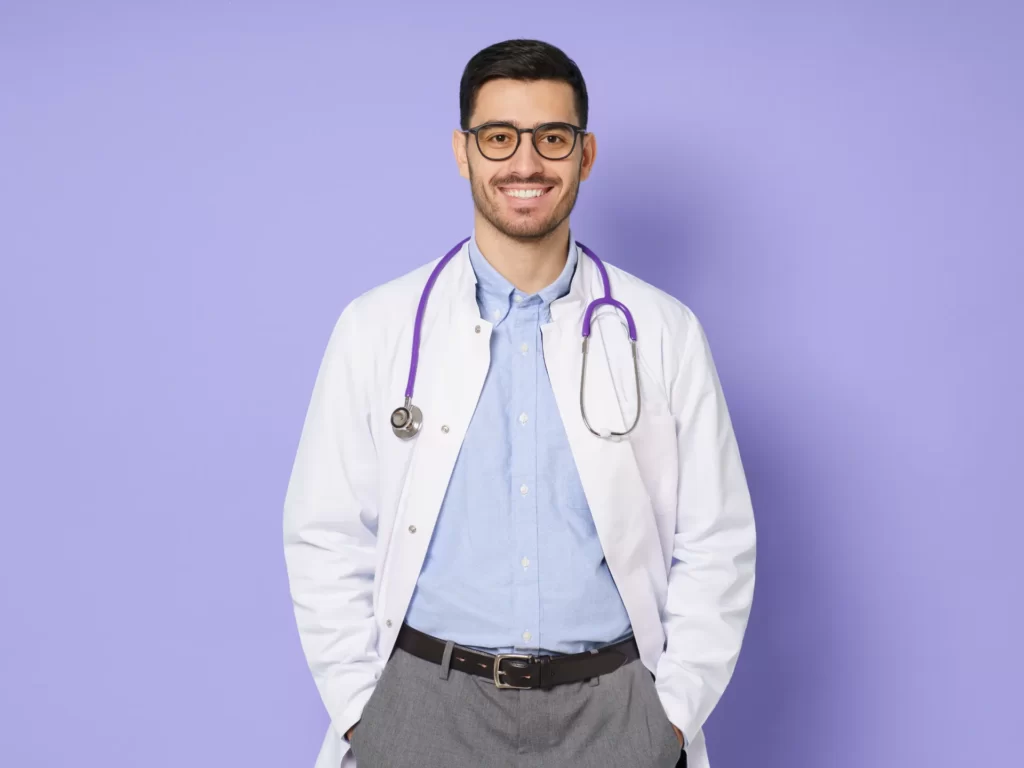 portrait of smiling young male doctor standing wit utc