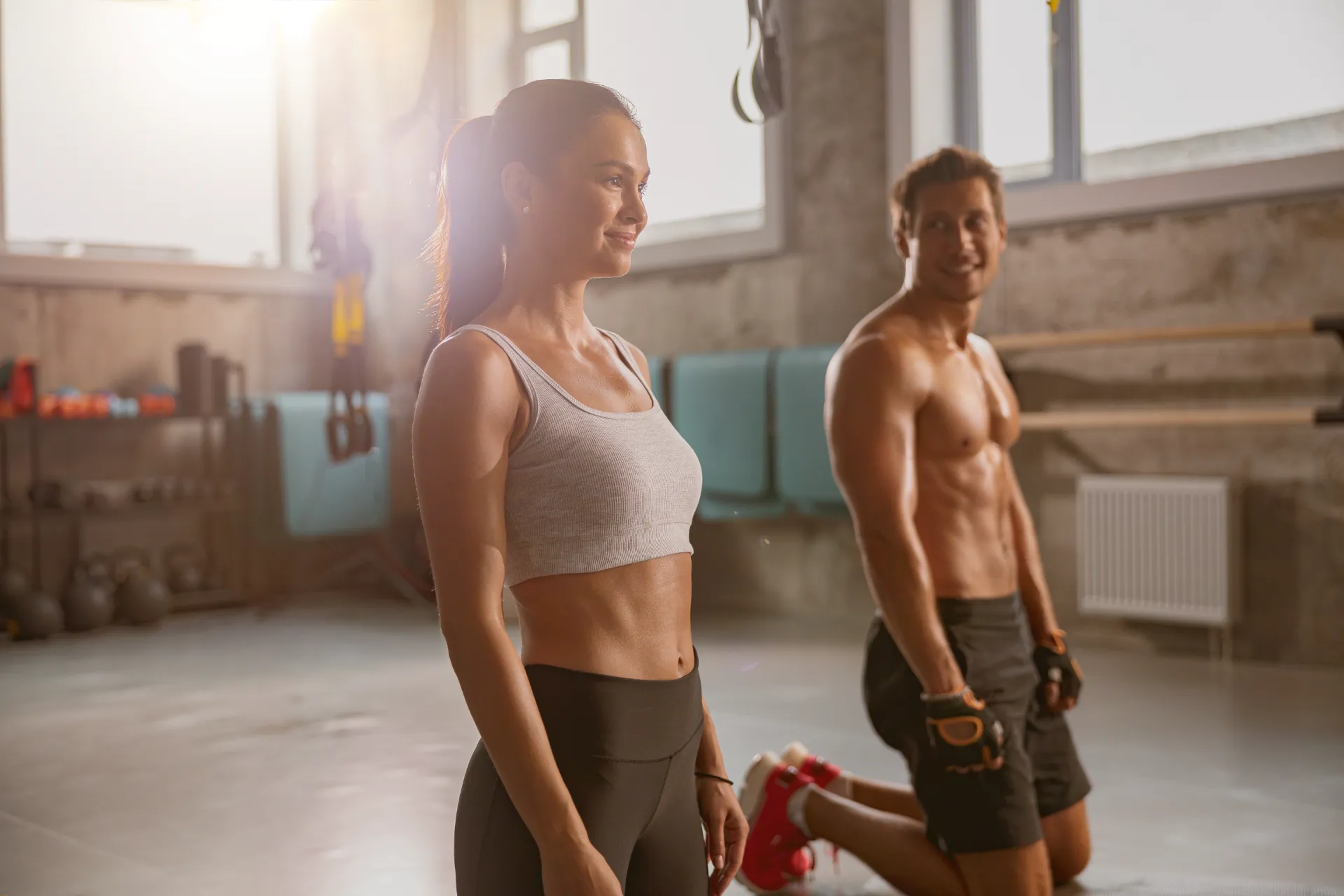 young woman and sporty man working out in the gym utc